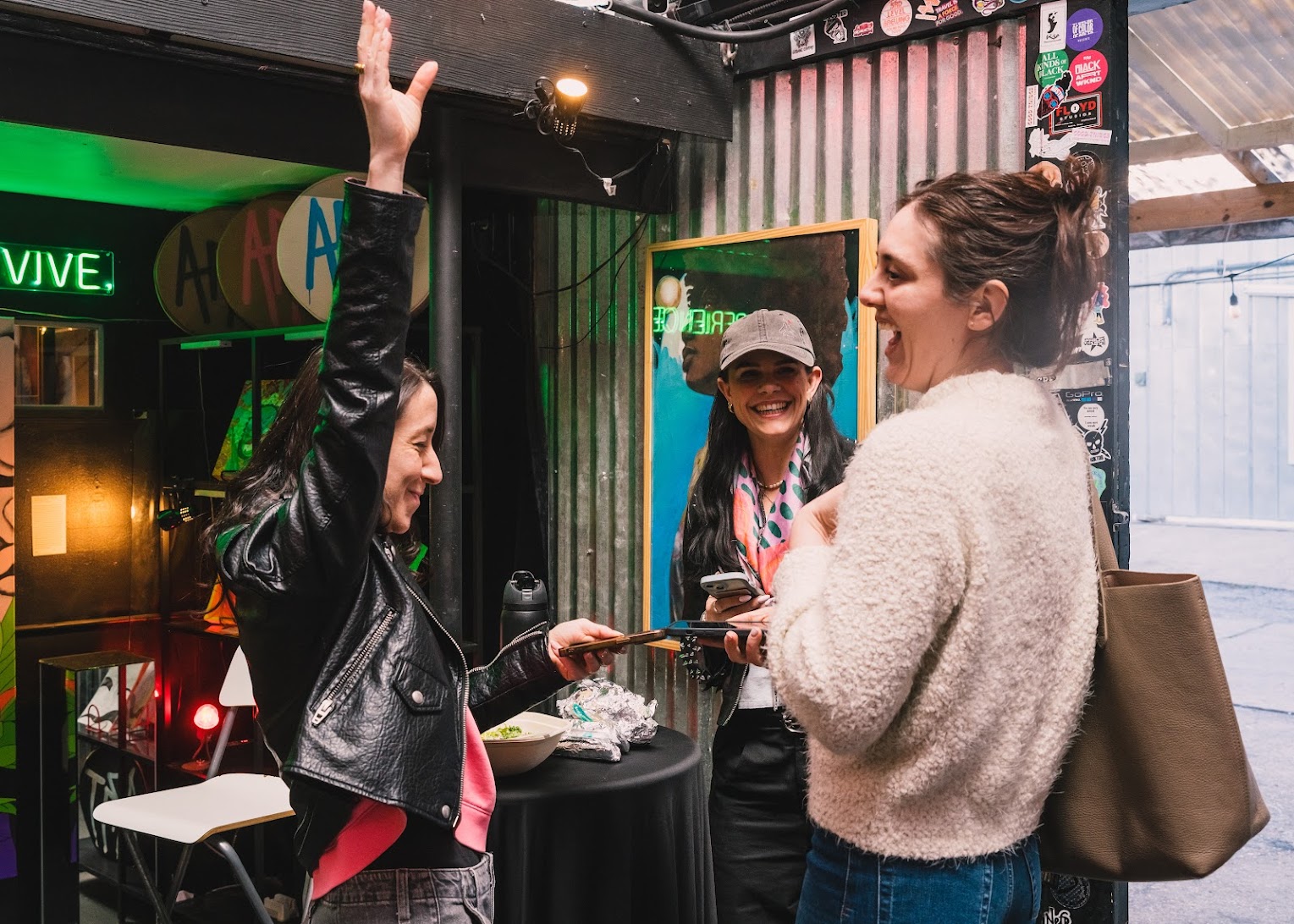Joyous connections made by three women tapping iphones
